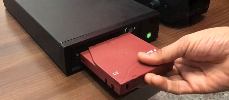 LTO tape being inserted in a tape drive